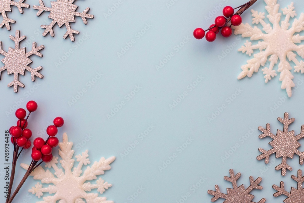 some snow flakes are arranged around a branch with berries some snow flakes are arranged around a branch with berries