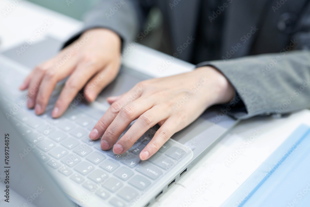 hands working on laptop keyboard hands working on laptop keyboard