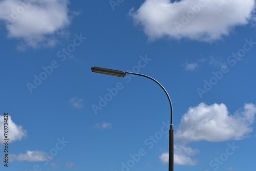 Street lamp on the background of the blue sky photo