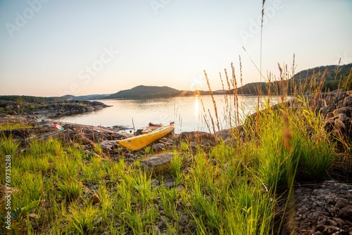 Yellow kayak on the shore of a lake during the sunset in Telemark, Norway