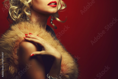 Girl's best friends concept. Femme fatale style. Portrait of rich young woman wearing expensive luxurious diamond accessories, furs, posing over burgundy background. Copy-space. Close up. Studio shot