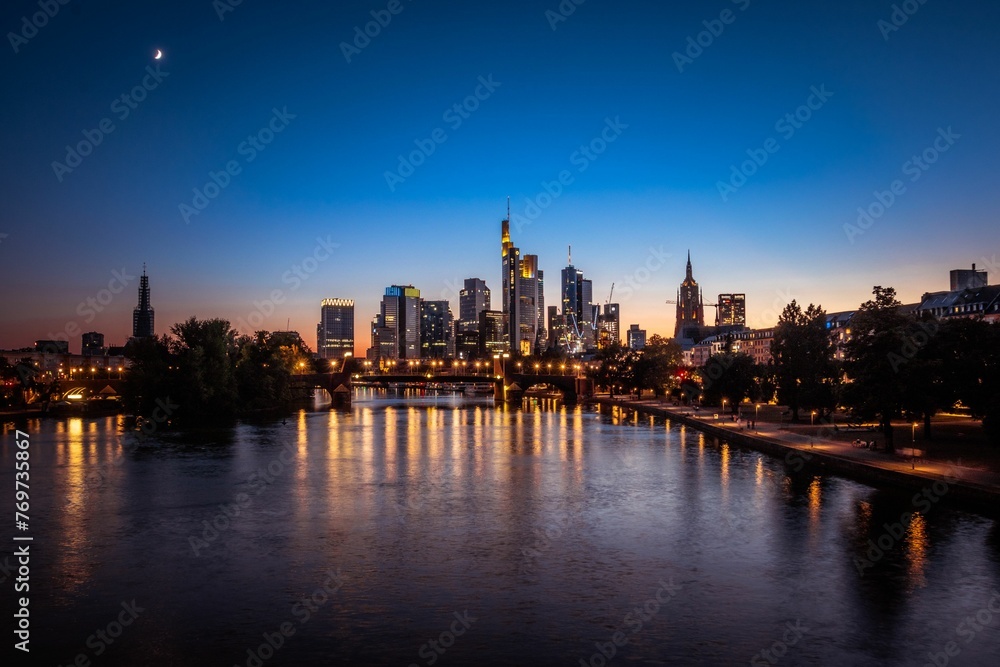 Aerial view of a vibrant cityscape of Frankfurt am main illuminated against the night sky