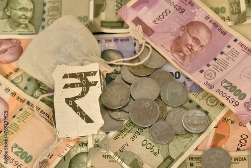 A closeup selective focus of an Indian digital currency with currency notes and Coins photo