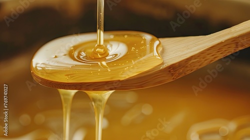 close up light vertical wooden flat spatula with straight dripping thick honey  