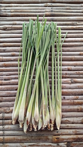 Fresh organic lemongrass (Cymbopogon) on bamboo background.