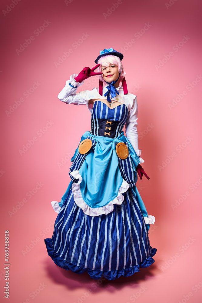 joyful young woman cosplaying anime character and showing peace gesture and looking at camera
