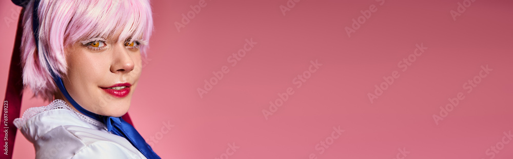 cheerful attractive female cosplayer in vibrant attire smiling at camera on pink background, banner cheerful attractive female cosplayer in vibrant attire smiling at camera on pink background, banner