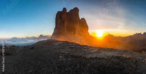 Panoramic photo of the famous Tre Cime peak in the Italian Dolomites in early autumn and the golden hour glow of the setting sun