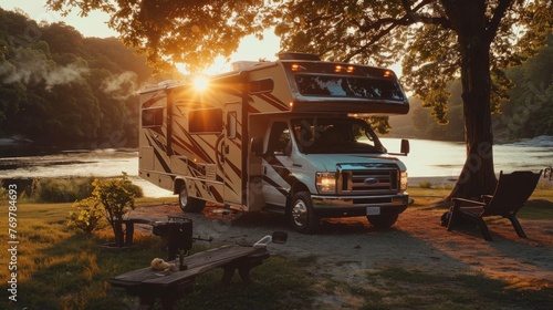 Class C RV parked at a scenic campsite during sunset