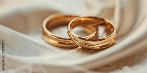 A close-up of two wedding rings intertwined to symbolize an anniversary.