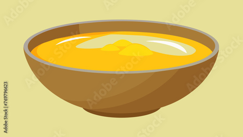  A bowl filled with golden ghee a type of clarified butter used in traditional Ayurvedic cooking and holistic therapies.