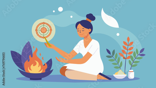  A practitioner burns a bundle of dried herbs circling it around a patients body to cleanse their energy in a traditional Ayurvedic practice