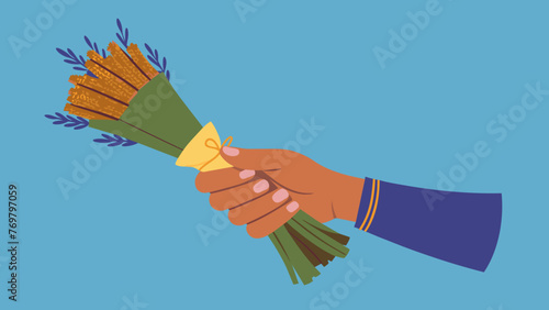  A traditional medicine practitioners hand holding a bundle of dried herbs ready to be bundled and burned as part of a cleansing ritual for the