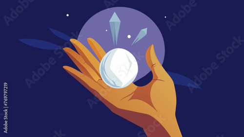  A shamans hand cradles a piece of selenite its smooth white surface reflecting the light. The crystal seems to be pulsing with a calming energy
