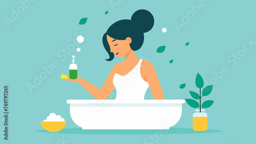  A woman adds a few drops of peppermint oil to her bath enjoying the invigorating and rejuvenating properties.