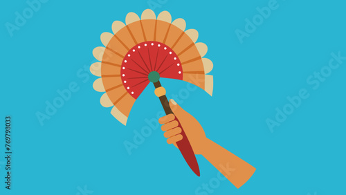 A beaded feather fan is held in someones hand used in traditional smudging ceremonies to energetically cleanse and purify a space or person.