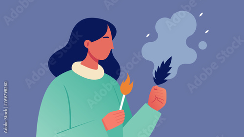  A macro shot of a person holding a small bundle of smudging herbs preparing to cleanse their space with the fragrant smoke.