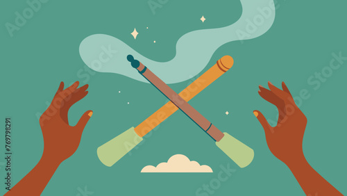  A pair of hands holding a smudging stick cleansing the room with smoke as a man plays a didgeridoo combining the power of sound and sacred photo