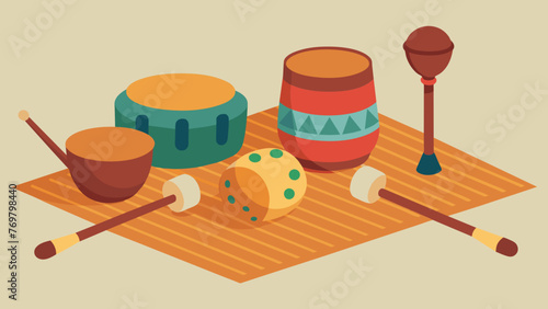  A group of instruments including a rainstick shakers and a miniature drum sit on a woven mat. Each instrument offers a different texture and