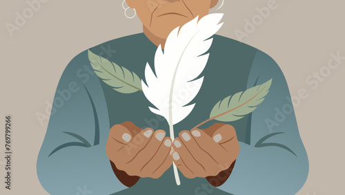 The worn hands of an elderly healer holding a bundle of dried leaves and a small delicate white feather. The leaves are thought to hold