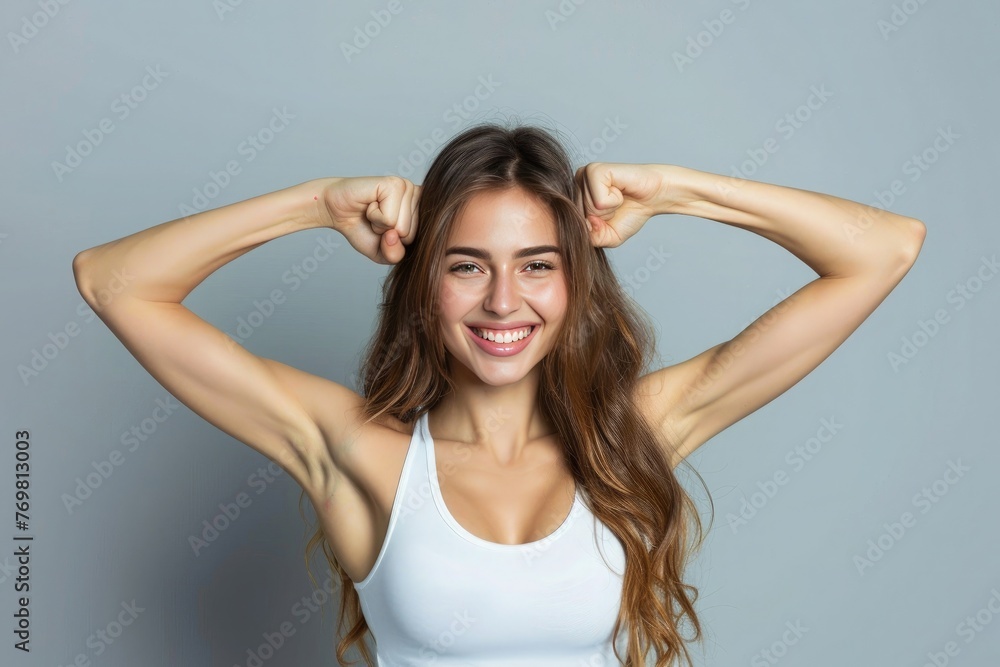Portrait of a happy elegant woman showing her biceps 