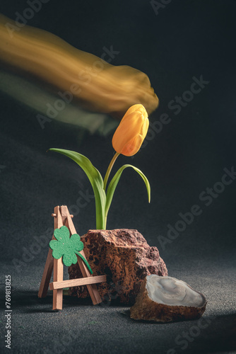 concept spring. freakebana. yellow tulip and Four-leaf clover. the concept of St. Patrick's Day photo