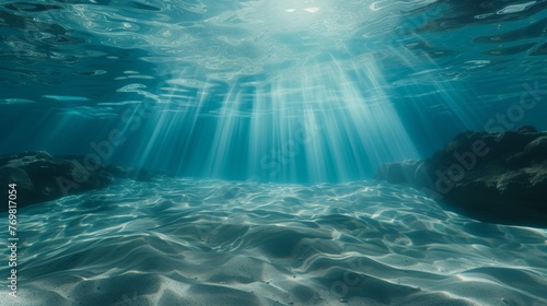 Underwater background featuring a deep blue sea with beautiful light rays piercing through the water