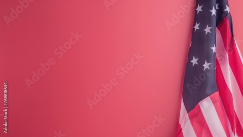 An American flag is draped elegantly against a vibrant pink background with ample copy space.