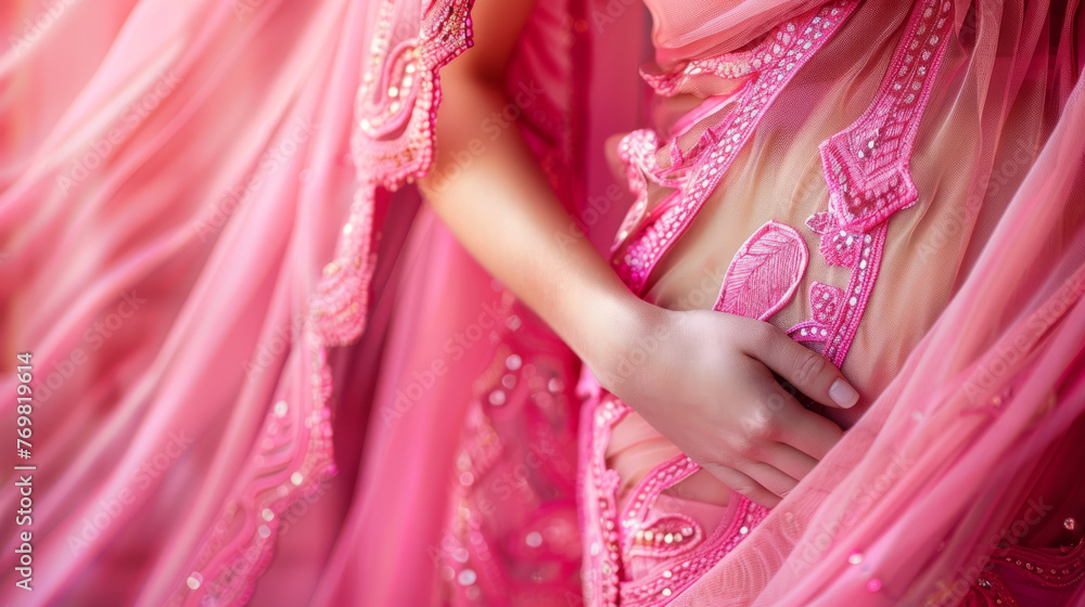 A radiant pregnant woman dressed in soft pink attire exudes elegance and grace. Her gentle demeanor and the delicate hue of her clothing encapsulate the beauty and serenity of pregnancy.