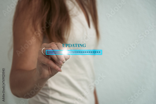 woman Installing software update on virtual screen, operating system upgrade concept. updating progress bar on virtual screen. copy space © robert