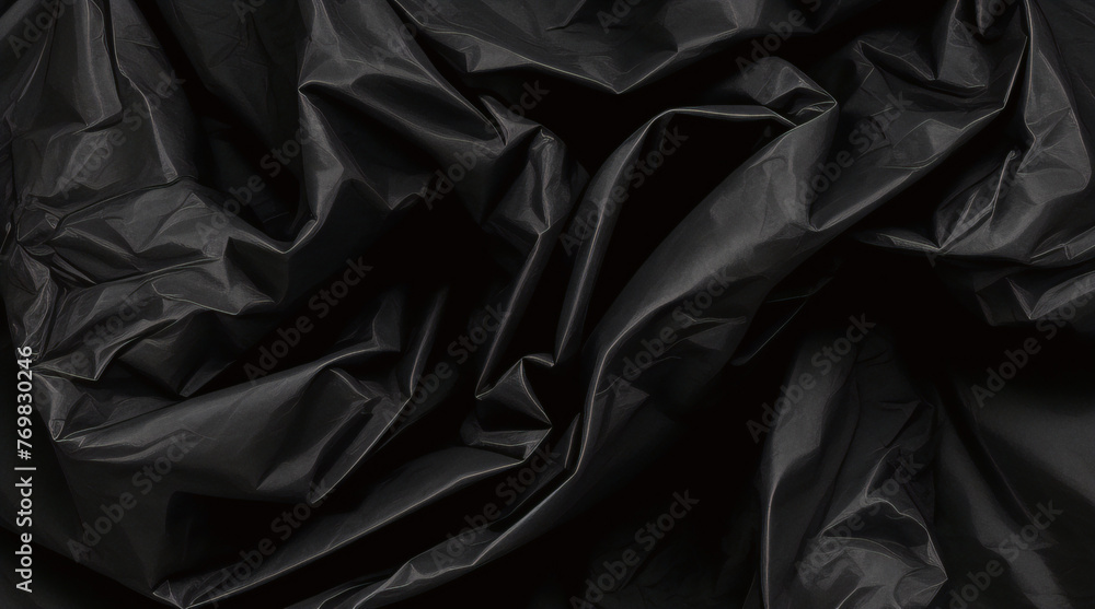 full frame abstract background of crumpled black plastic film bag