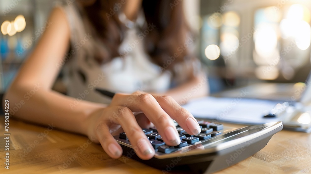 Fototapeta premium AI Generated businesswoman is calculating financial report with calculator and holding a pen.