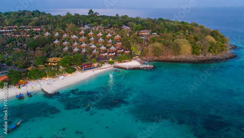 Beach villas at Long beach of Koh Phi Phi island  Krabi  Thailand. Tropical paradise white sand beach with turquoise waters of Andaman sea  aerial view at sunset.