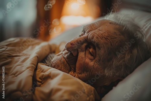 Elderly man in bed receiving care at hospice facility for long-term rehabilitation photo