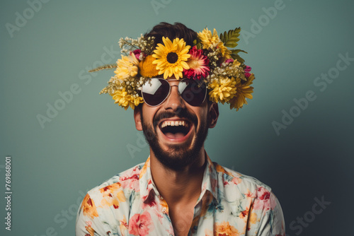 Happy young man wearing flowers gesturing while winking eye