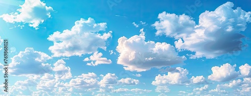a blue sky adorned with white clouds in a banner panorama background, offering a serene and expansive view.