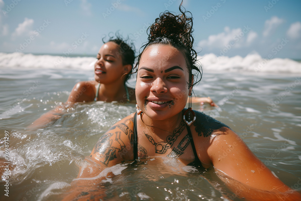 Two women enjoying a refreshing swim on the beach on a sunny summer day. Vacation and beach concept. Two women enjoying a refreshing swim on the beach on a sunny summer day. Vacation and beach concept.