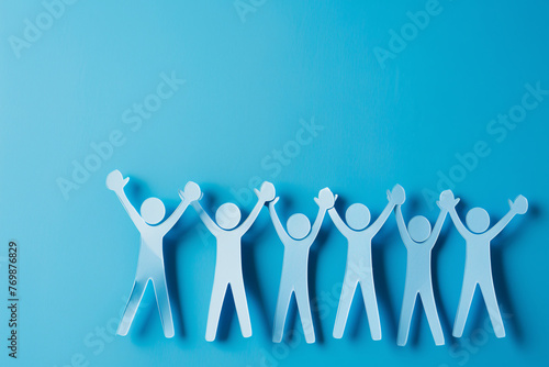 Blue paper people standing and high fiving on blue background with copy space for text, business concept of team work or community group action symbol © Got Pink?