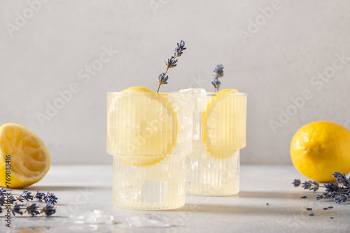 Cold infused detox water or lemonade with lemon and lavender. Summer soft drinks for freshness party.