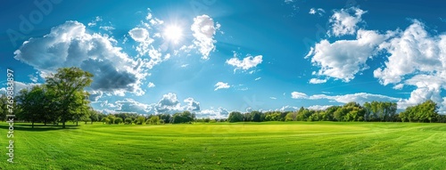 golf course set against a backdrop of blue skies  scattered clouds  lush trees  and rolling hills  with vibrant green fairways and white sand bunkers.