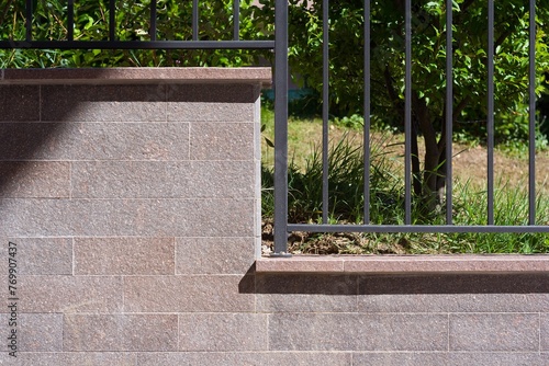 Fotomural detail of a porphyry border wall and metal railing