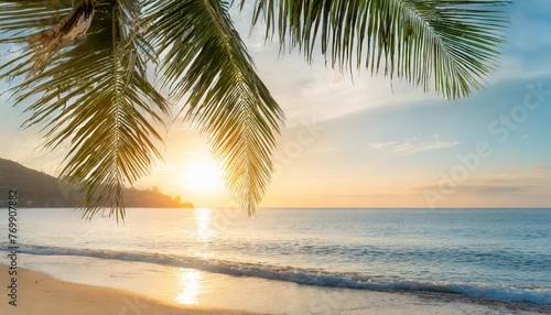 a summer vacation holiday background of a tropical beach and blue sea at sunset with the sun on the horizon and green palm tree leaves © Susan