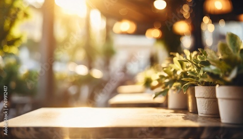 empty abstract blurred bokeh background of modern cafe or restaurant with potted green plants can be used for display products mock up with copy space