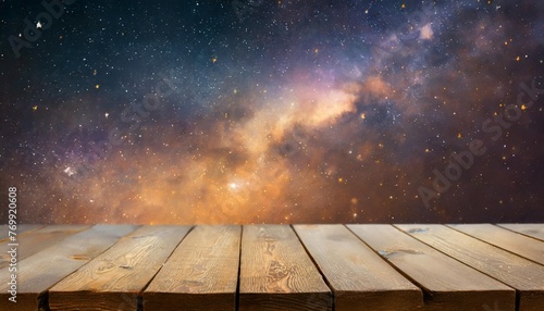 an empty wooden table on the background of a starry space with a nebula