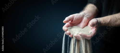 Time passing, sand falling through mans fingers background