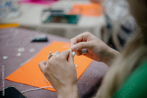 Professional jewelry designer making handmade jewelry in studio workshop close-up. Fashion, creativity and handmade concept. 
