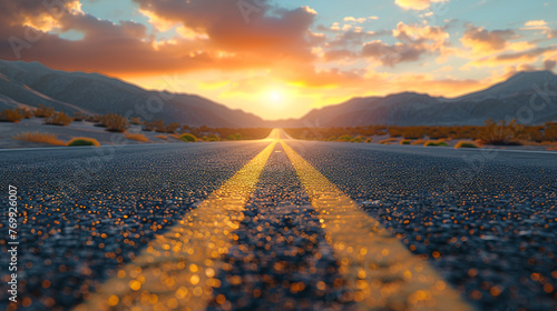Photo of empty asphalt road with yellow dividing strip in the middle against sunset background. View from the yellow stripe photo
