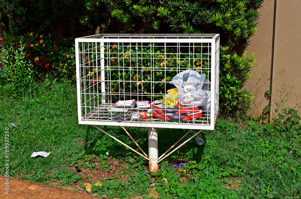 Grid trash can on sidewalk in Ribeirao Preto, Sao Paulo, Brazil