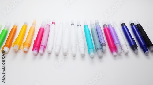 An array of colorful markers ordered by hue creates a visually pleasing gradient on a clean white background, perfect for art and education themes