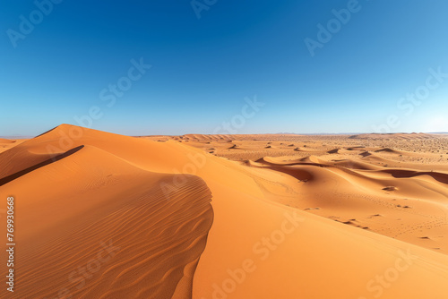 A desert landscape with a large sand dune in the foreground